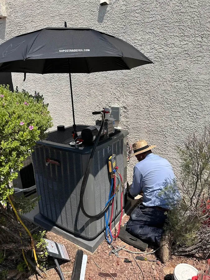 HVAC technician performing outdoor AC maintenance in Upper Nazareth
