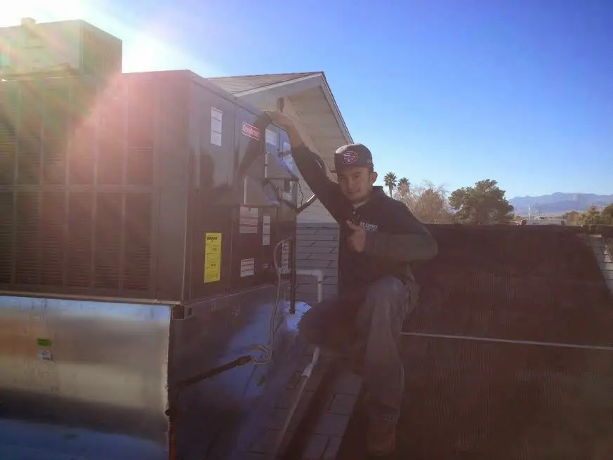 HVAC technician performing AC Tune-Up on a rooftop unit in Upper Nazareth